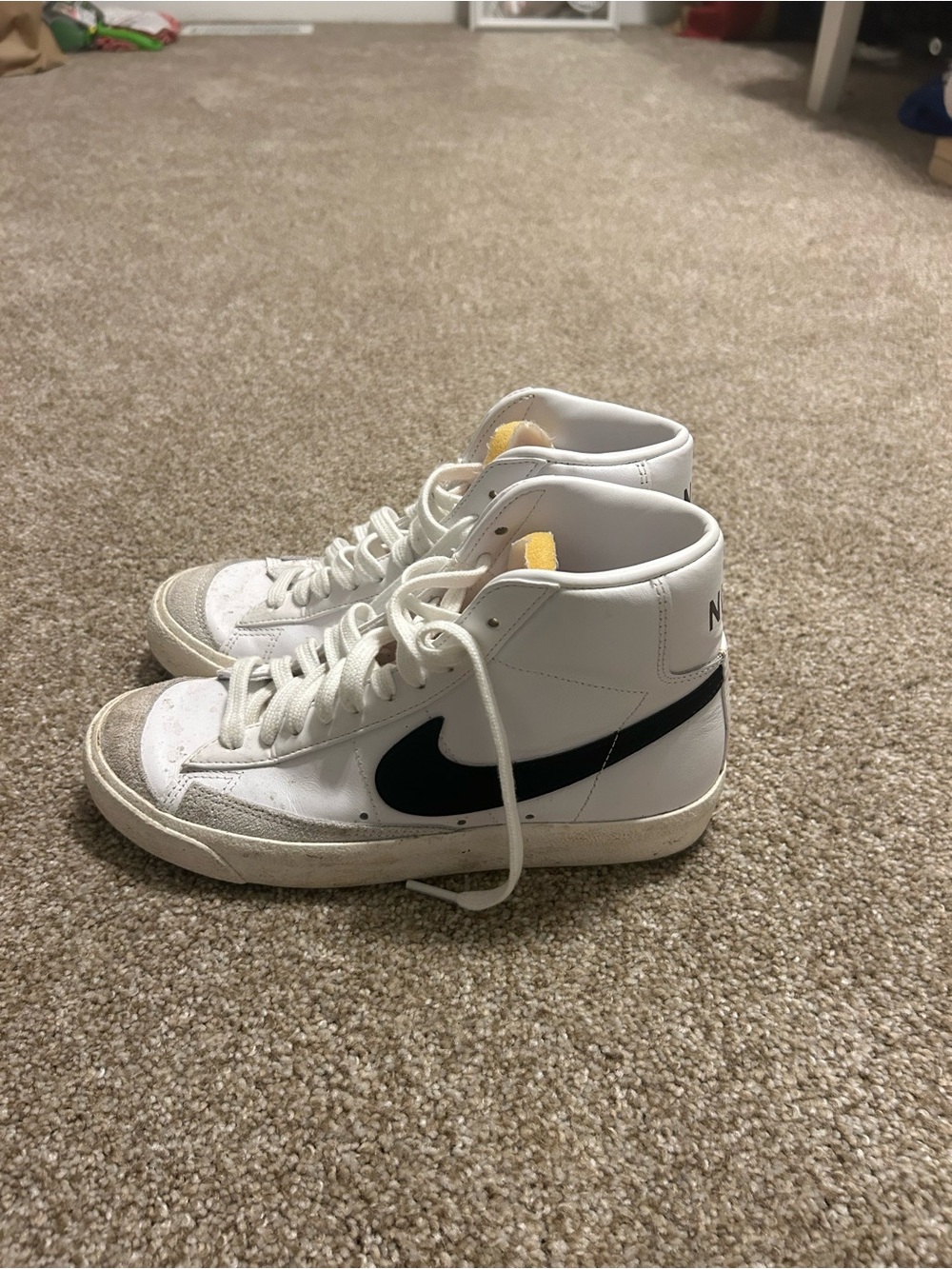 Nike White High-Top Sneakers with Black Swoosh and Yellow Tongue Accent